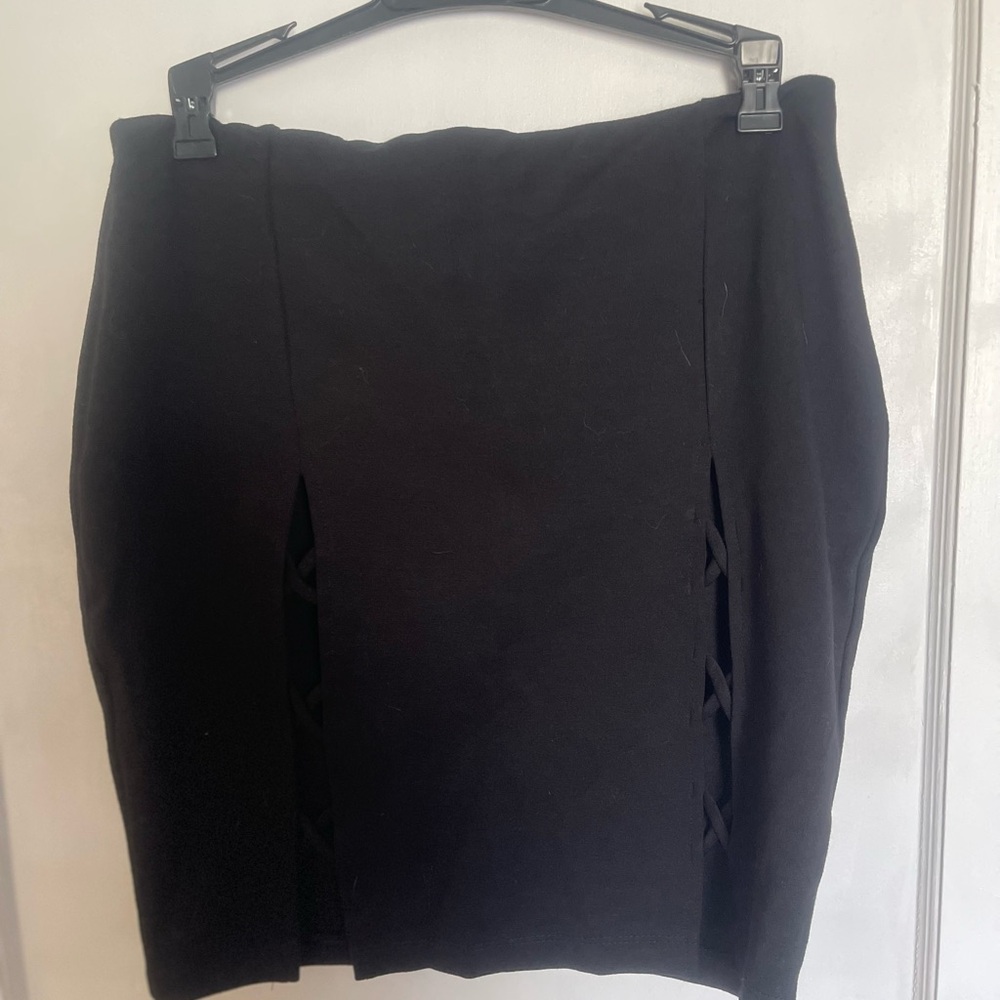 Black Mini-skirt with cut out detailing.